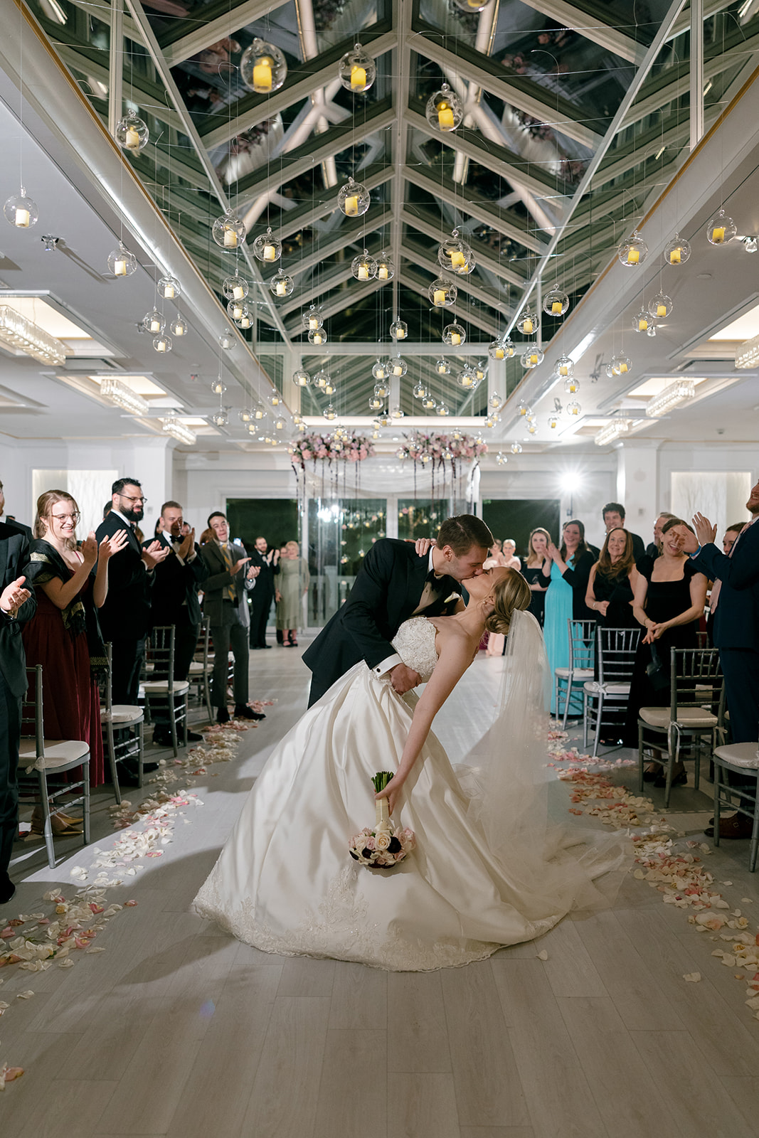 Newlyweds kissing while the husband dips the wife