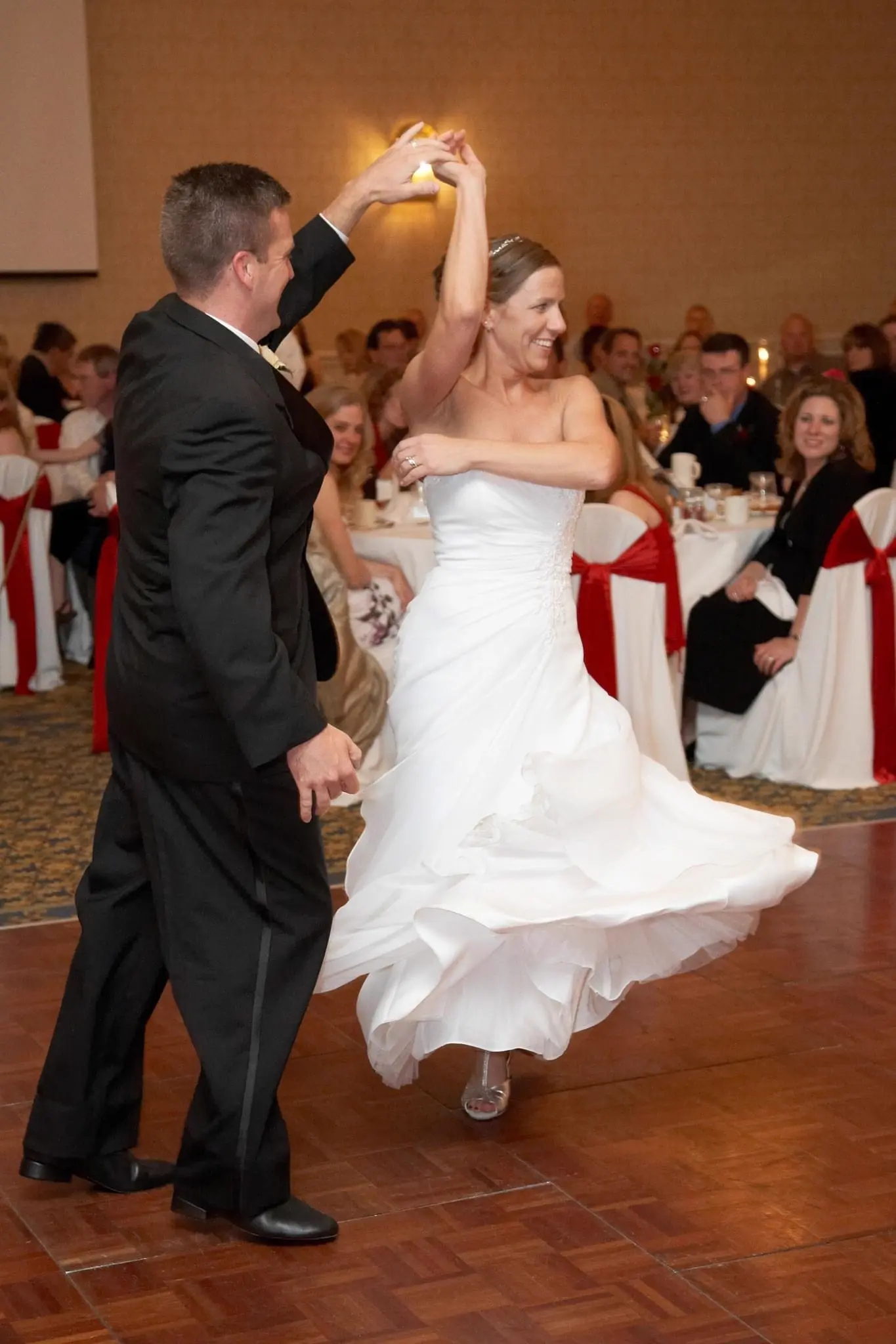 A groom spinning his bride on the dance floor