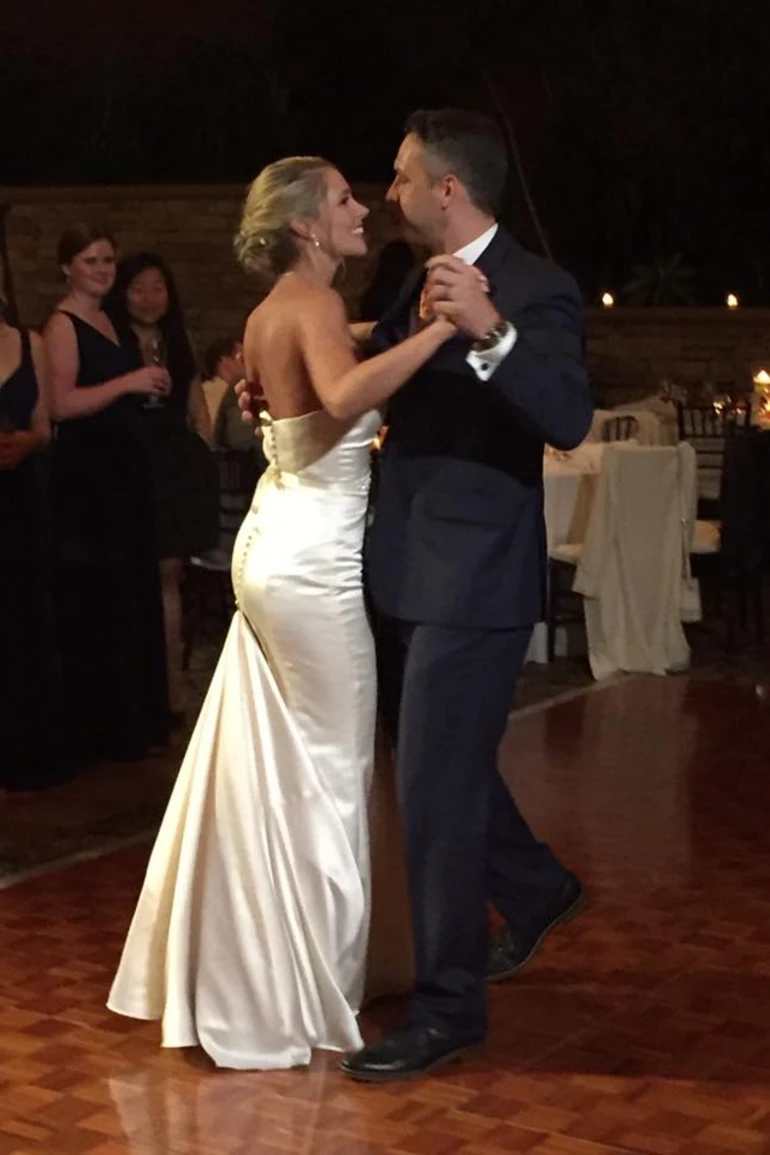 A couple dancing in wedding attire